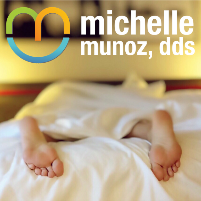 person sleeping with feet sticking out of the blankets