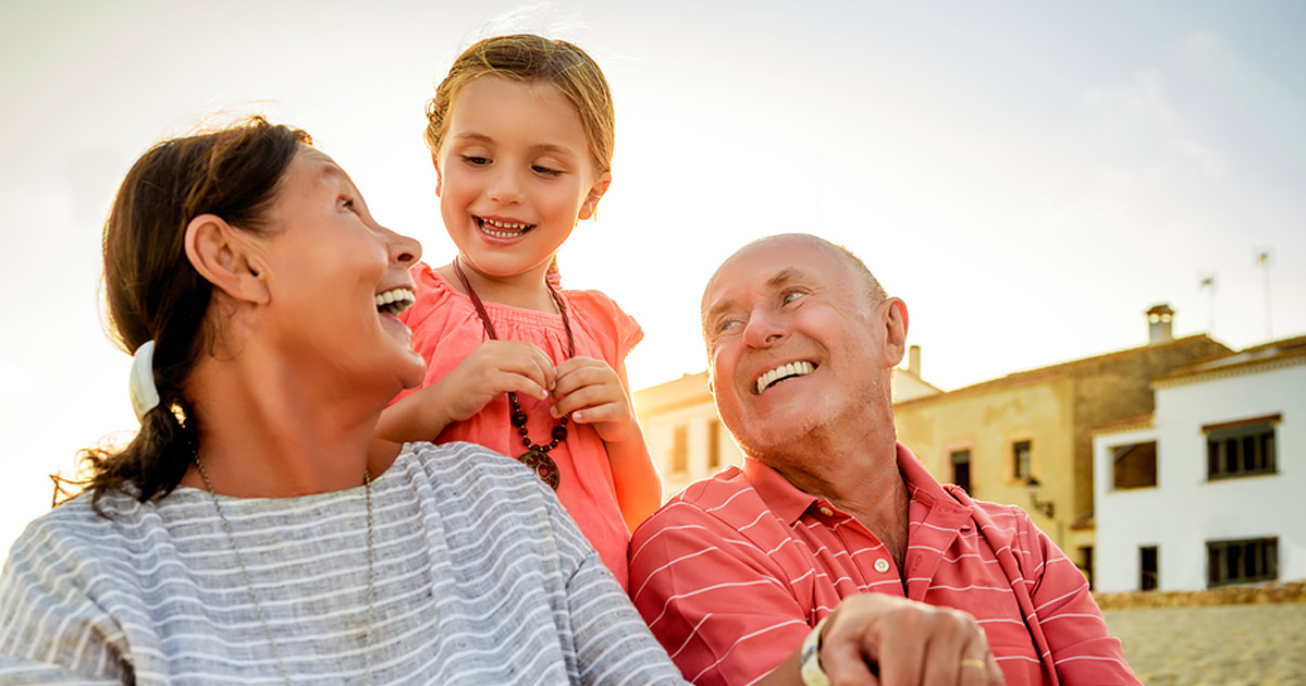 Grandparents and granddaughter smiling