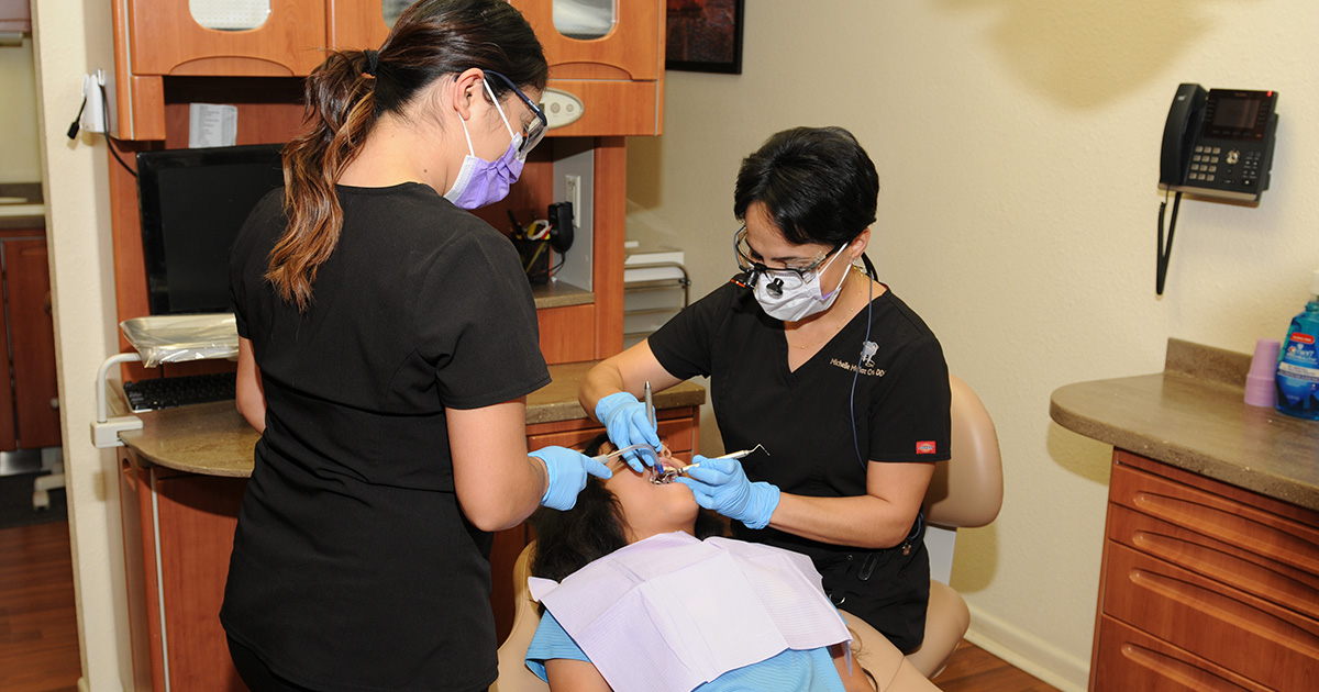 child patient getting work done by Dr Munoz and assistant