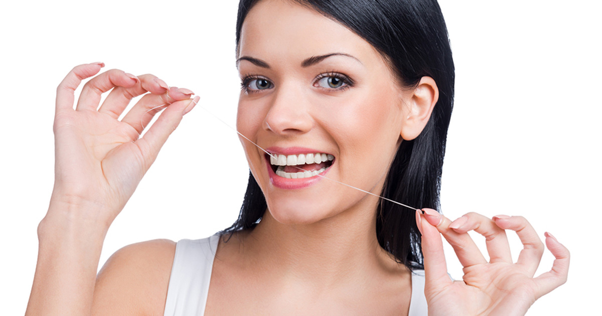 woman flossing teeth