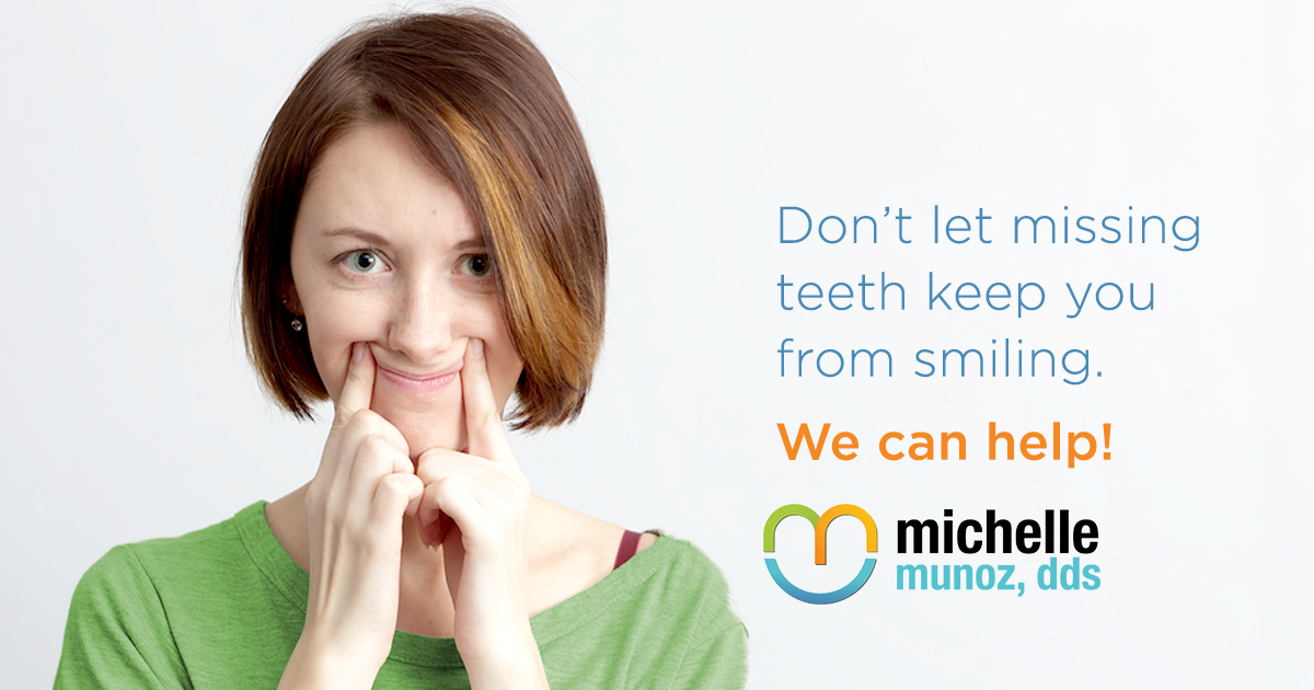 woman forcing a smile with her fingers