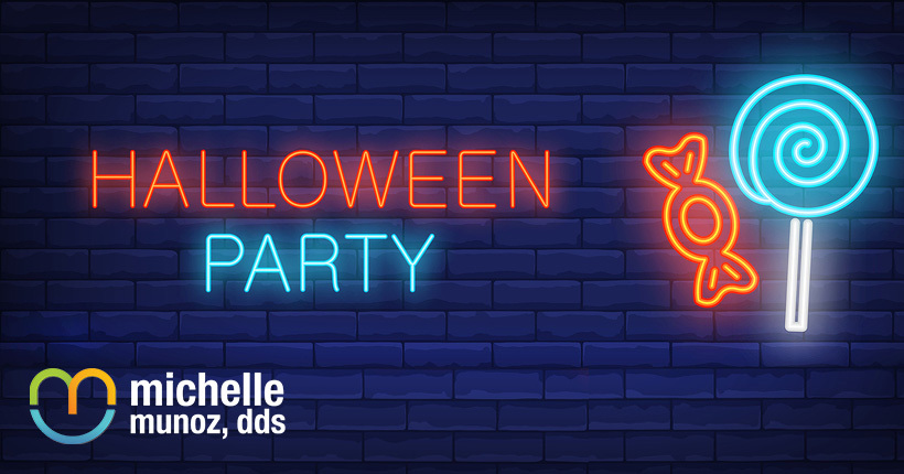 Neon sign of candy and the words "Halloween Party"